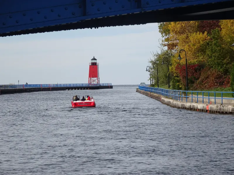 The Pine River and the red Charlevoix South Pier Light