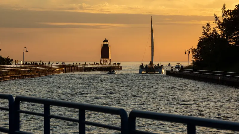 A boat passing the pier on the channel