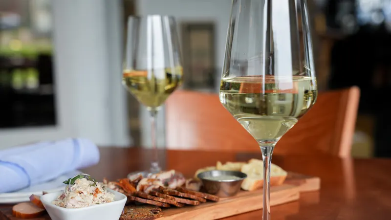 Wine glasses and plates on a table by the window